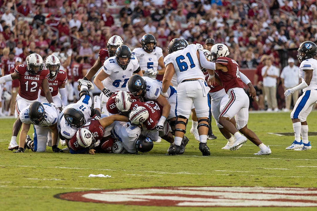 Gamecocks make a defense pile onto an Eastern Illinois player traveling down the field.