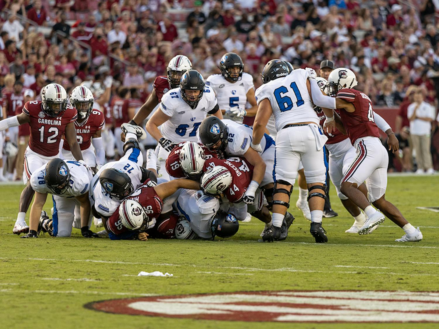 Gamecocks make a defense pile onto an Eastern Illinois player traveling down the field.