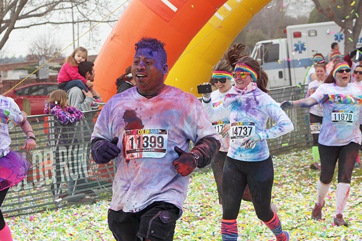	A man finished the race with the side of his face caked with purple powder. 
Heidi Stone/The Daily Gamecock