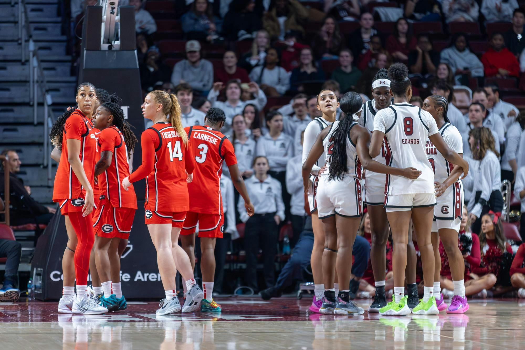 Players from the South Carolina and Georgia women's basketball teams gather in separate huddles on the court during a game at Colonial Life Arena on Jan. 11, 2026. The Gamecocks defeated the Bulldogs 65-43.