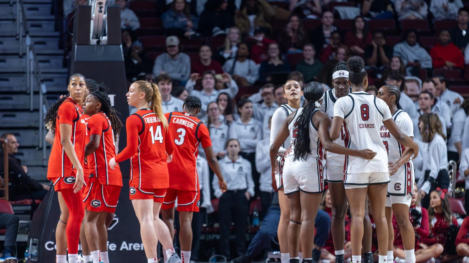 Players from the South Carolina and Georgia women's basketball teams gather in separate huddles on the court during a game at Colonial Life Arena on Jan. 11, 2026. The Gamecocks defeated the Bulldogs 65-43.