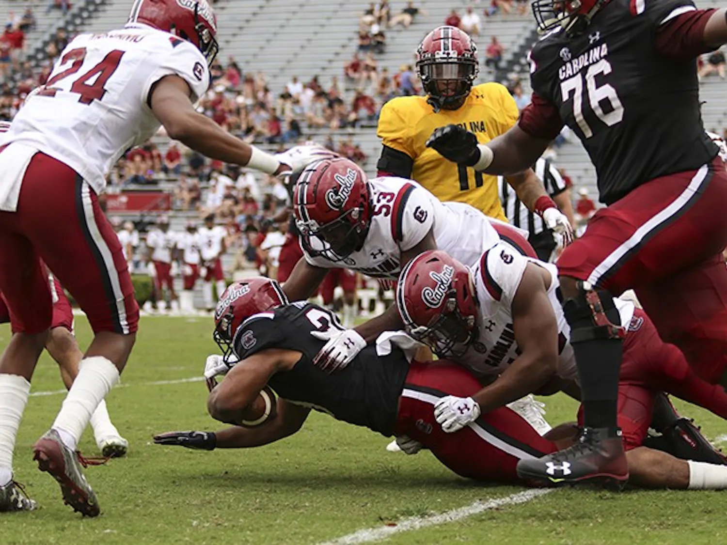 Gamecock players make a tackle during the spring game at Williams-Brice Stadium during the 2019 spring game. 