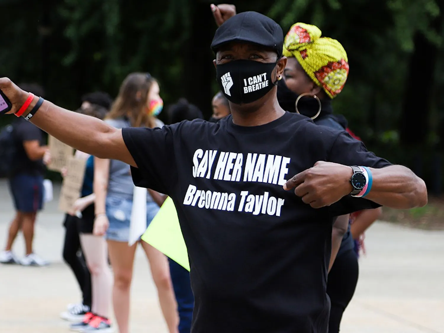 Protester Clarence Turner stands in front of South Carolina's state capital wearing a T-shirt reading "SAY HER NAME Breonna Taylor" and a facemask with the BLM symbol and the phrase "I Can't Breathe" in support of George Floyd.