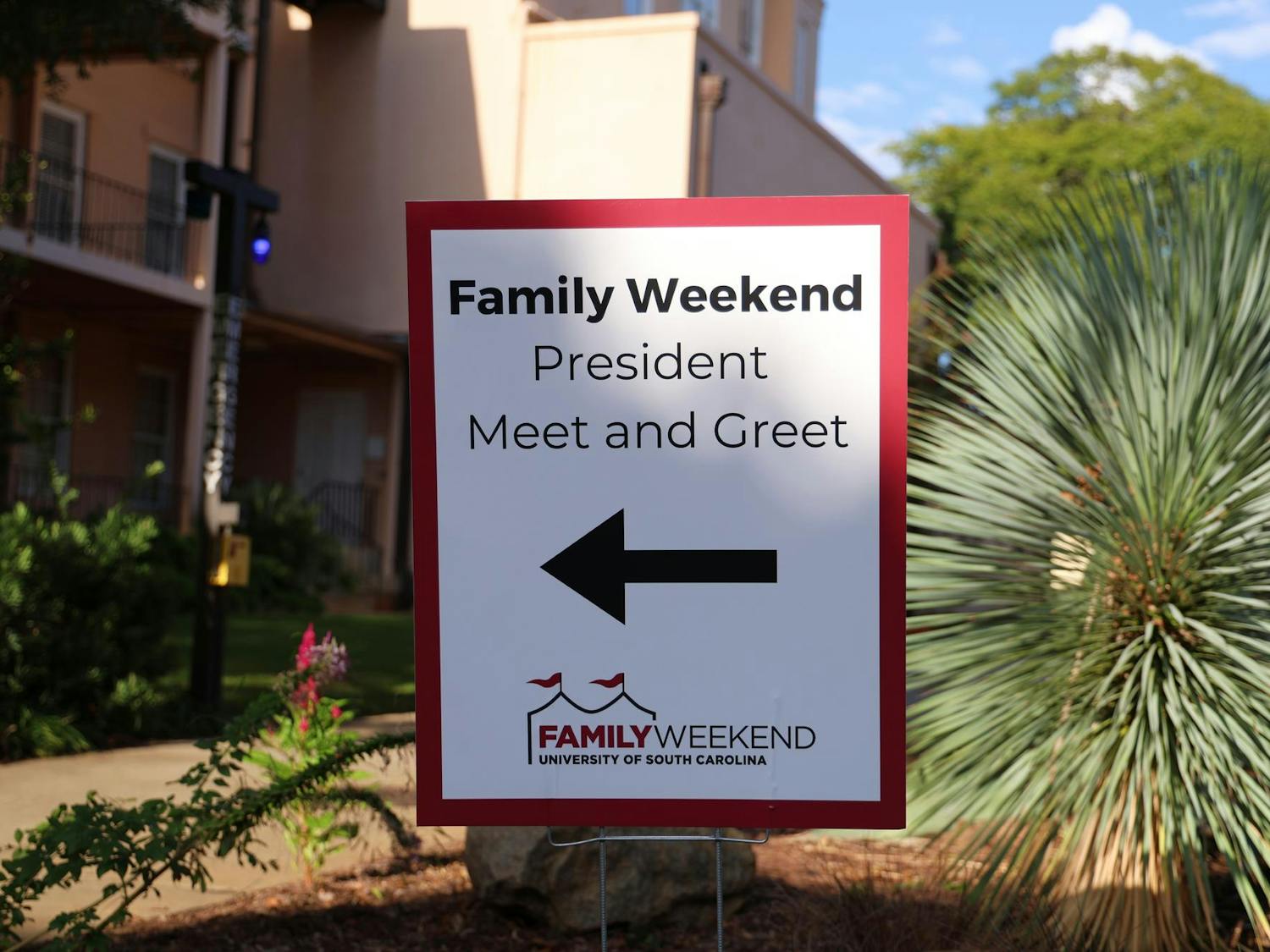 A Family Weekend sign, located next to the USC smokestack, directs visitors to the President Meet and Greet event at the Horseshoe on Sept. 20, 2024. USC hosted multiple events over the weekend, welcoming families of students to campus.