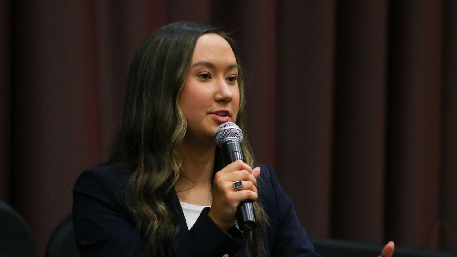 Presidential candidate and third-year political science student Emily “Emmie” Thompson answers a question at the Student Government debate on Feb. 15, 2023. She promotes her campaign by advertising “tangible” goals and promises.