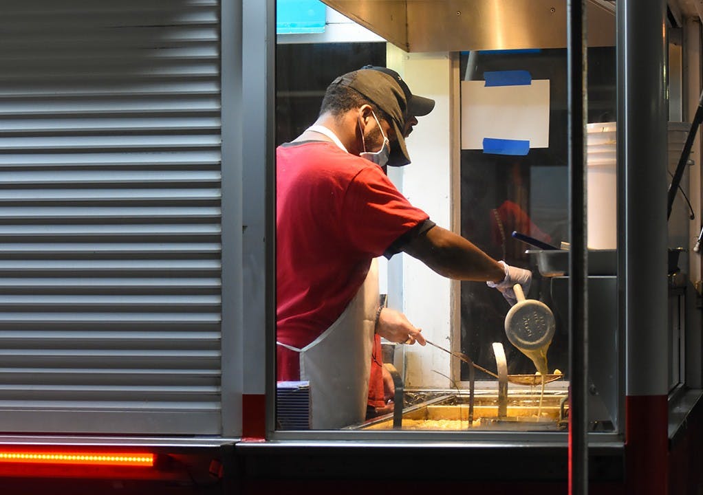 A cook frying funnel cakes, a popular confection at the State Fair.&nbsp;