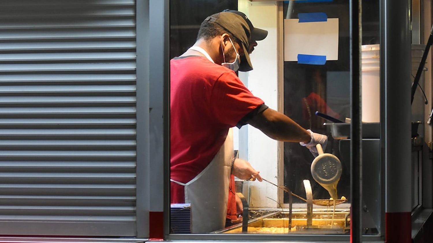 A cook frying funnel cakes, a popular confection at the State Fair.&nbsp;