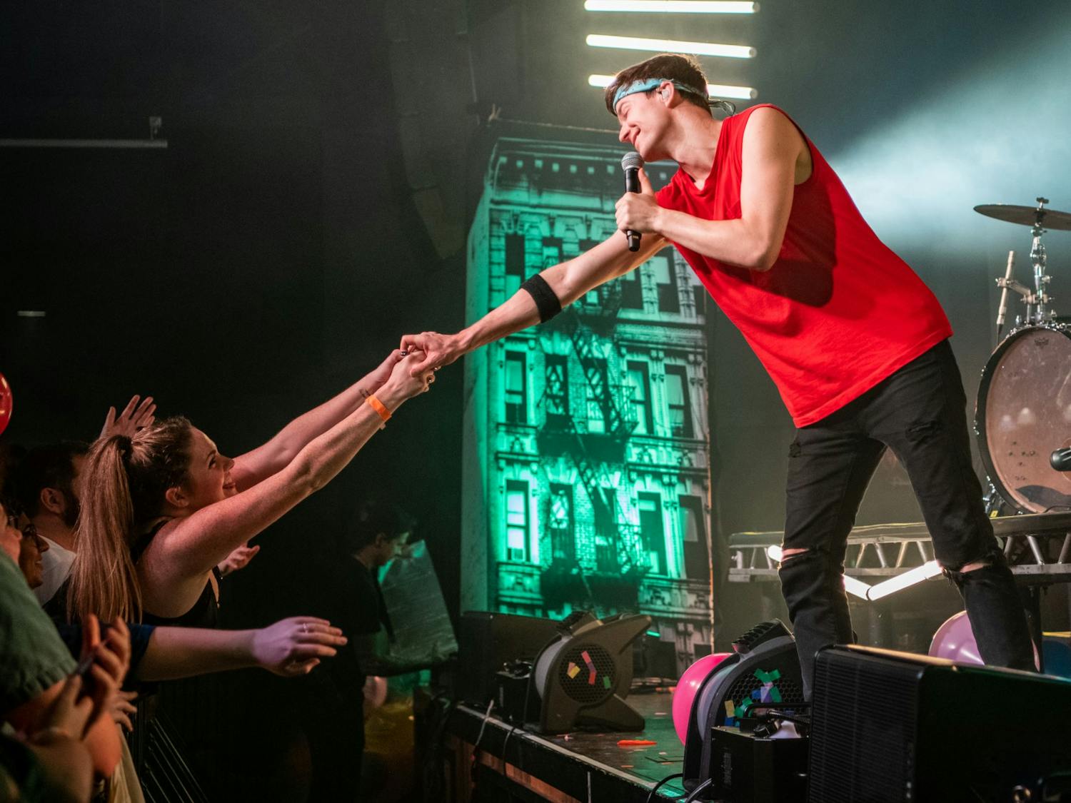Matt Johnson holds hands with a fan during a song at their concert at the Senate in November 2019. Johnson interacted with individual fans multiple times throughout the show.