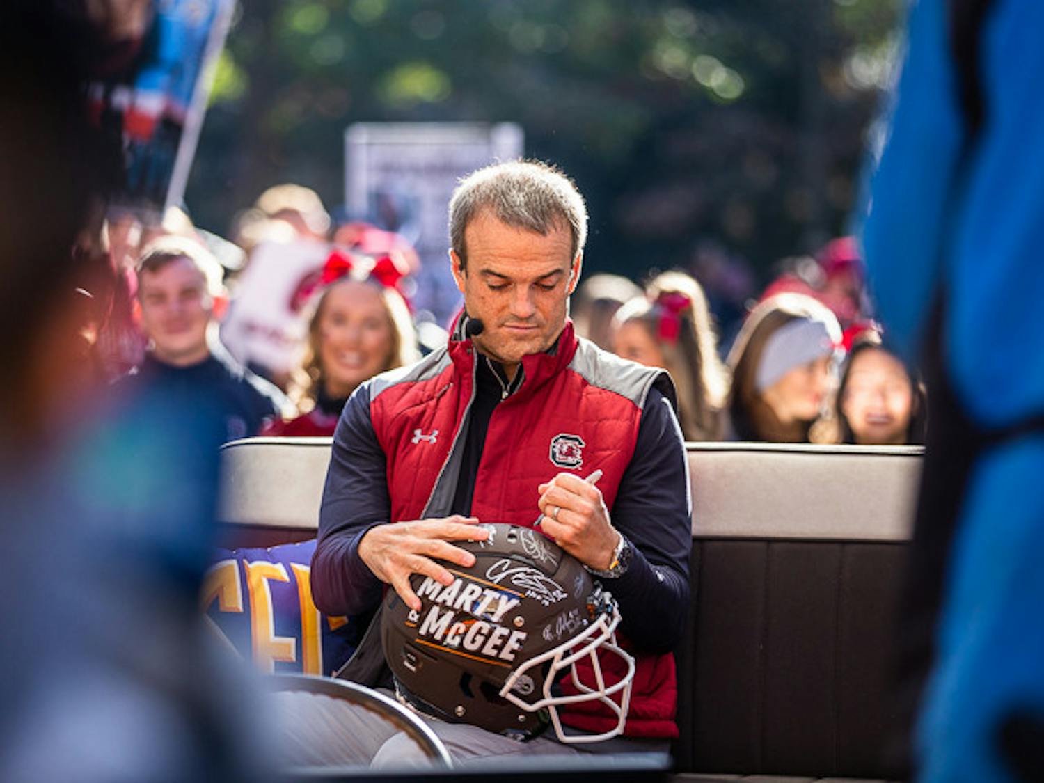Head coach Shane Beamer signs one of the helmets at the end of his interview during the Marty &amp; McGee pregame show on Nov. 19, 2022. The pregame show took place at the Horseshoe prior to SEC Nation.