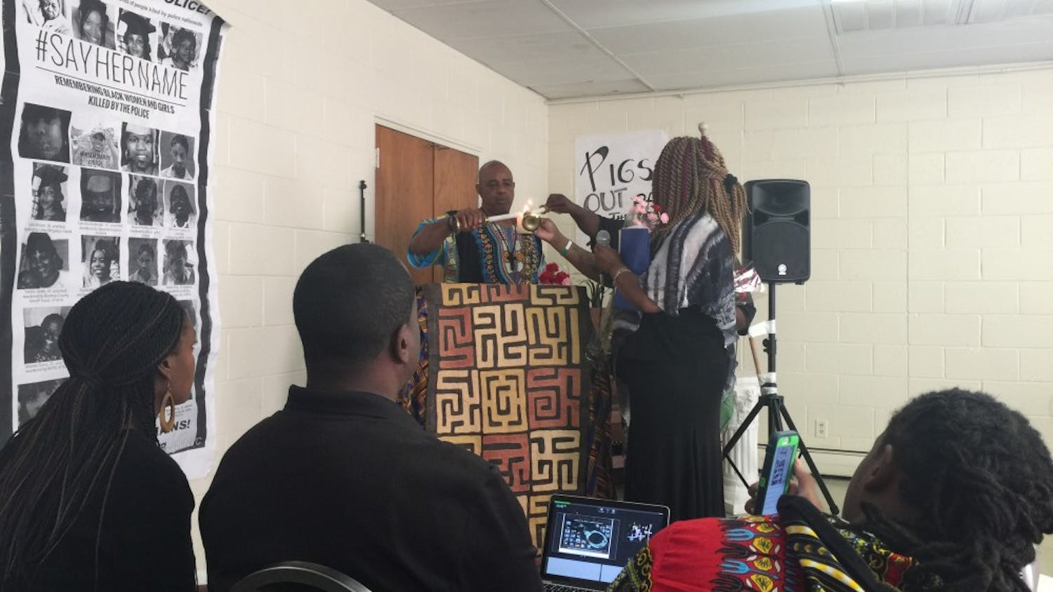Black Lives Matter teach-in attendees light candles in remembrance of their loved ones who were killed by police at Greenville's Martin Webb Learning Center on Saturday, Sept. 24.