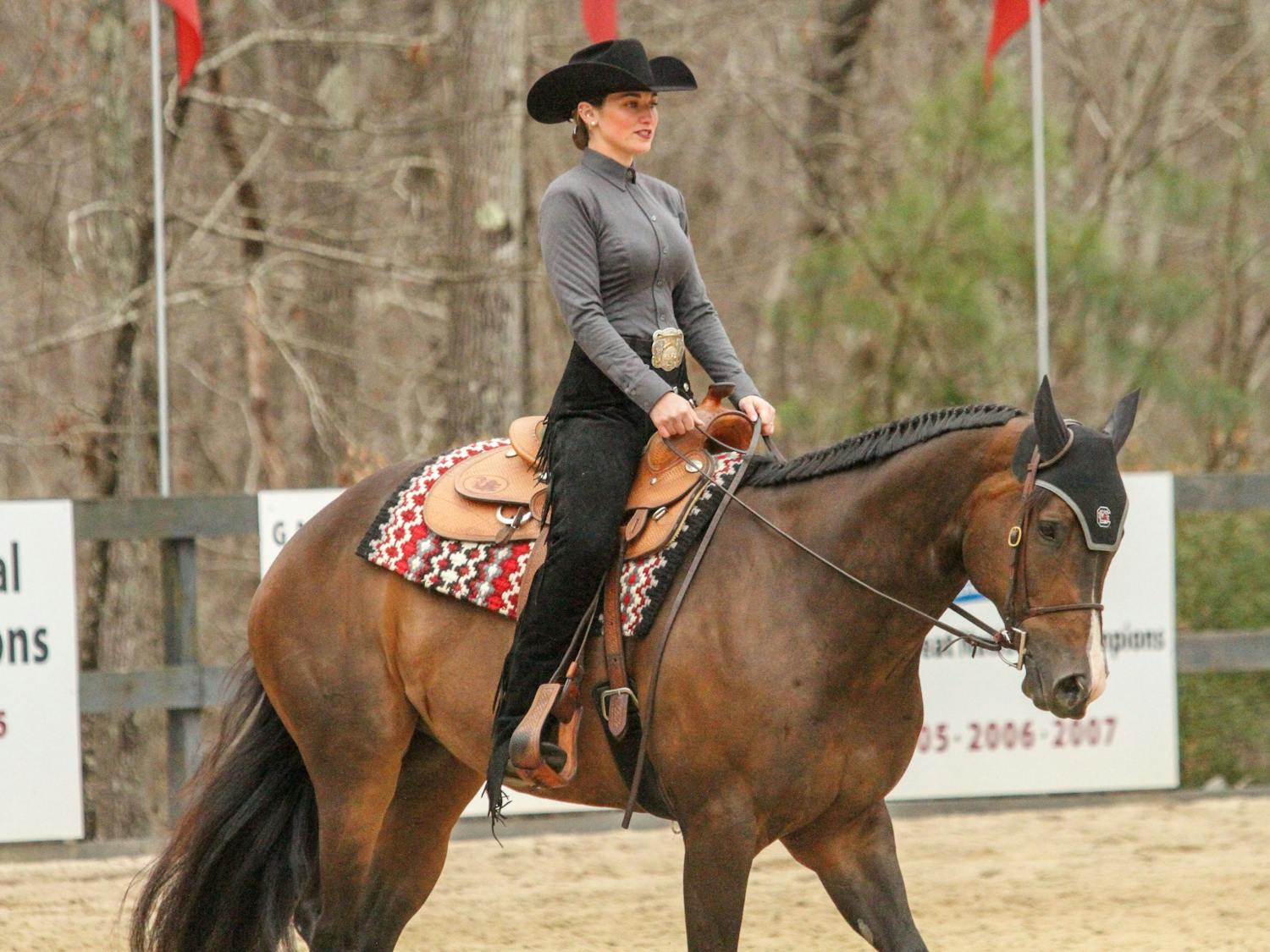 Senior Kiersten Beckner, mounted on Willy, competes in the horsemanship category during the meet against Texas A&amp;M at One Wood Farm on Feb. 11, 2023. Before every meet, Beckner listens to music to get in the zone and drinks a specific carbonated beverage. “I have to have a can of Coke to drink,” Beckner said.