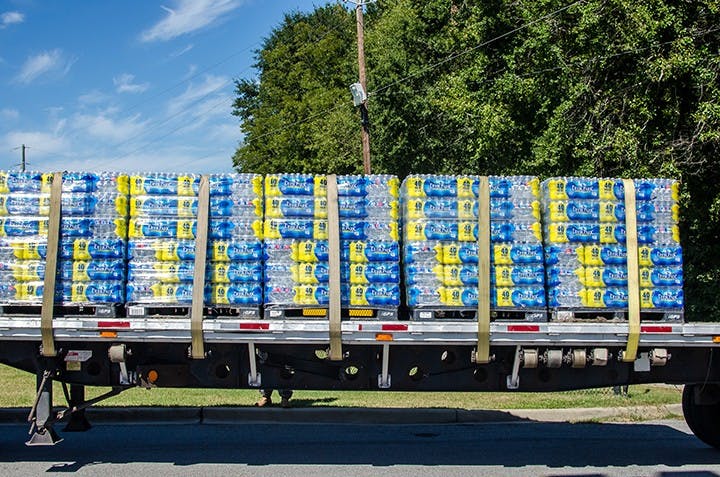 Pallets of water are delivered to Lower Richland High School for distribution on October 6.