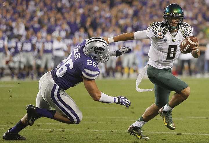 Quarterback Marcus Mariota of Oregon knows a little bit about winning. The sophomore has piloted the Ducks thorugh the BCS thicket. A constant in the national title conversation in recent years, Mariota keeps the high-octane Oregon offense humming with his dual-threat skills. (Travis Heying/Wichita Eagle/MCT)