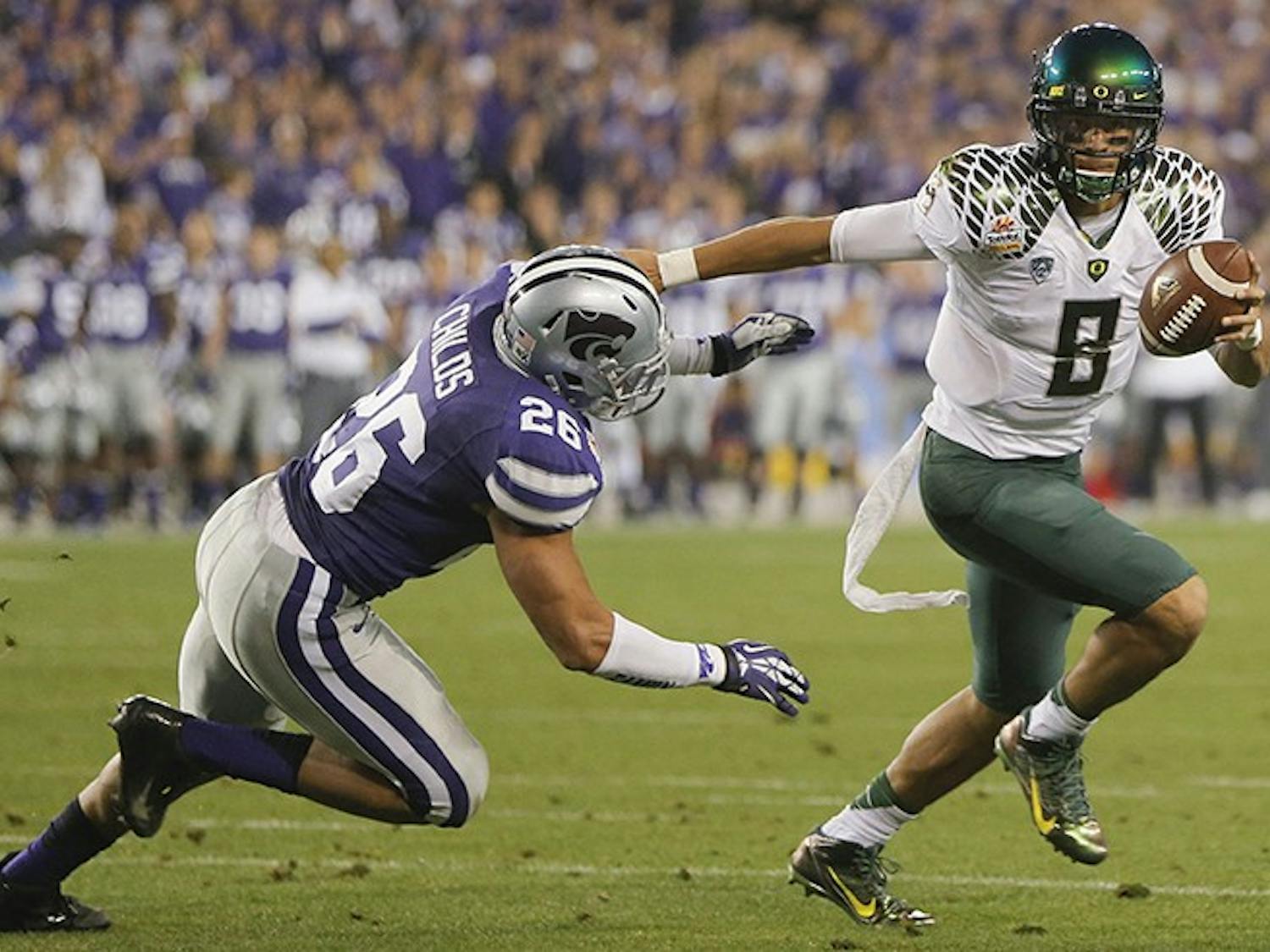 Quarterback Marcus Mariota of Oregon knows a little bit about winning. The sophomore has piloted the Ducks thorugh the BCS thicket. A constant in the national title conversation in recent years, Mariota keeps the high-octane Oregon offense humming with his dual-threat skills. (Travis Heying/Wichita Eagle/MCT)