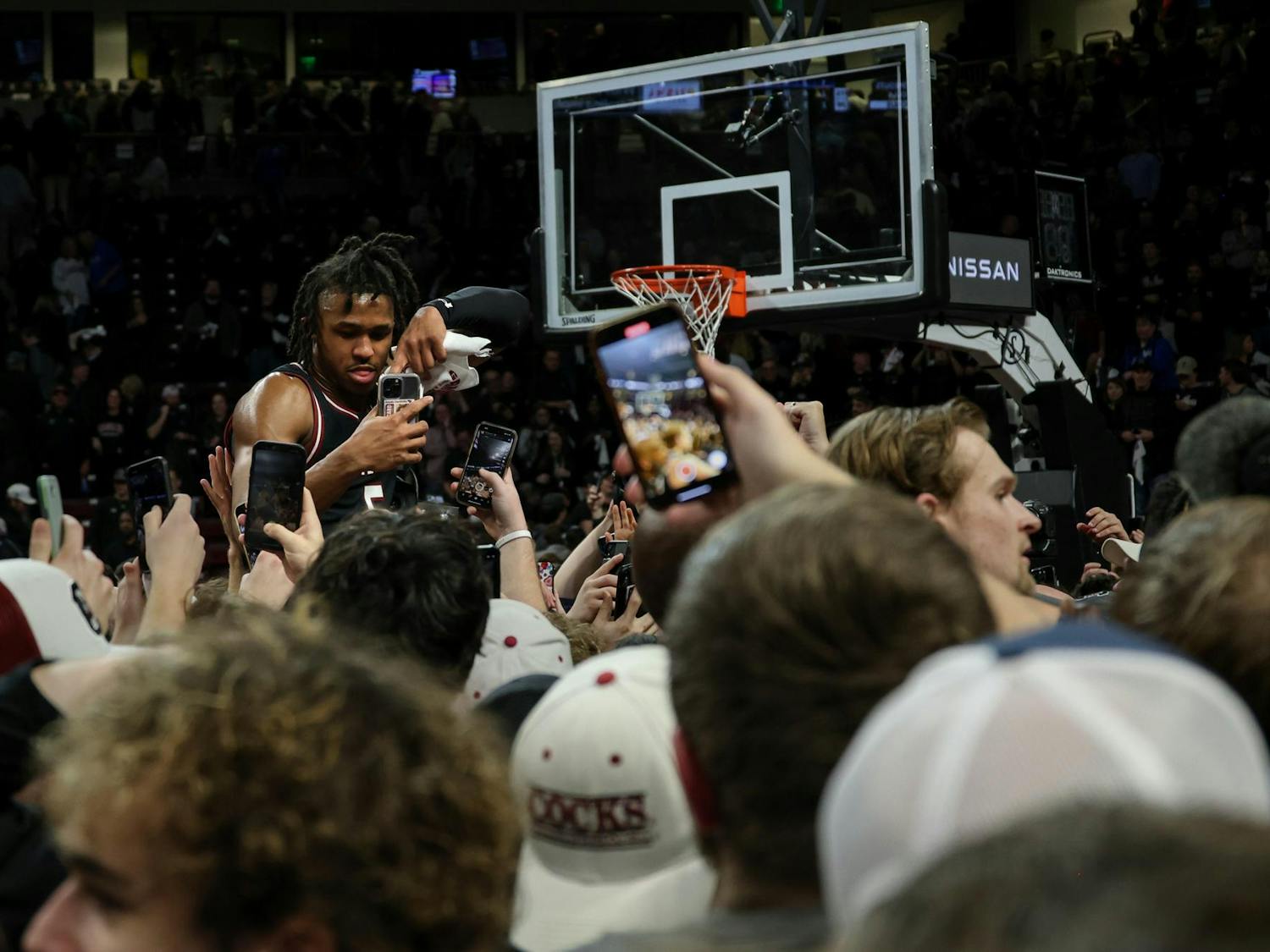 During the post-game celebration at Colonial Life Arena, fans lifted junior guard Meechie Johnson while he took videos on their phones. Johnson scored 14 points for South Carolina in its 79-62 victory over No. 6 Kentucky on Jan. 23, 2024.
