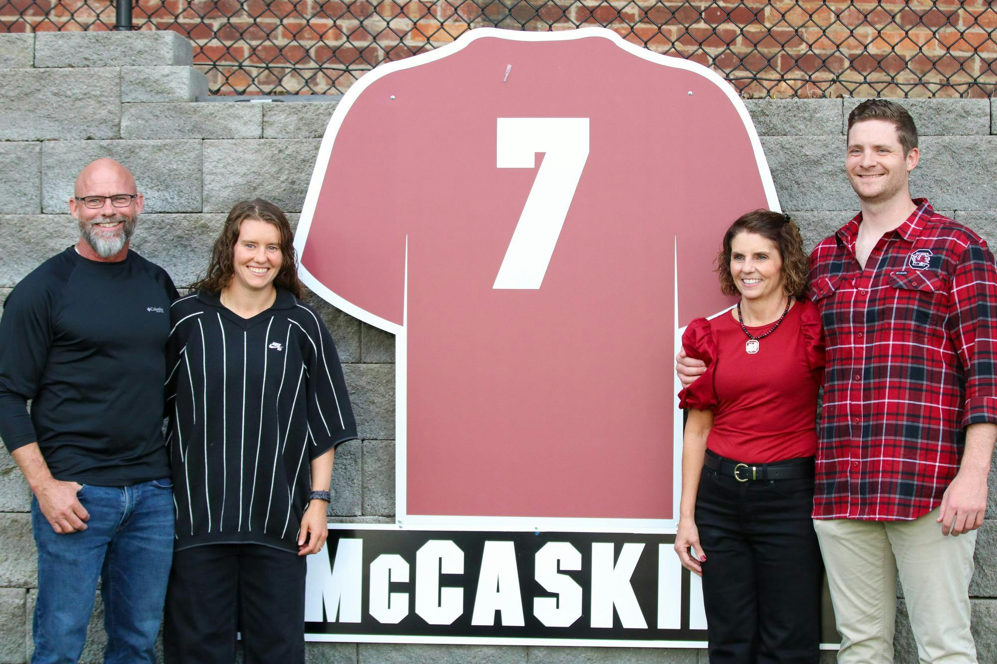 Former South Carolina women’s soccer player Savannah McCaskill and family pose beside her retired jersey at Stone Stadium on Oct. 19, 2025. McCaskill finished her college career as one of only three Gamecocks to reach 100 points.