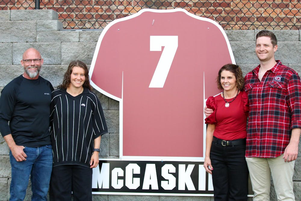 <p>Former South Carolina women’s soccer player Savannah McCaskill and family pose beside her retired jersey at Stone Stadium on Oct. 19, 2025. McCaskill finished her college career as one of only three Gamecocks to reach 100 points.</p>