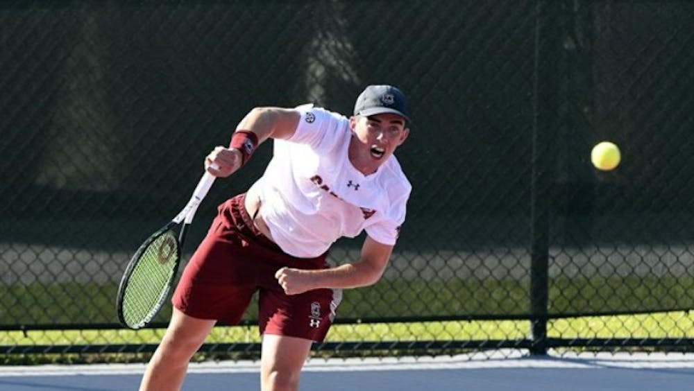 Freshman Connor Thomson serves in South Carolina's loss to #3 Tennessee.