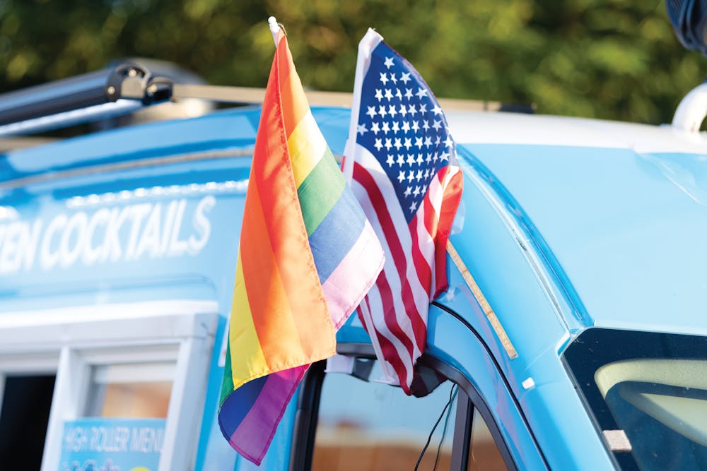 An LGBTQIA+ flag sits alongside a U.S. flag in a vendor’s truck window during the Outfest festival on June 4, 2022 on Park Street in Columbia, SC. Outfest featured performances, food and vendors in honor of Pride month.