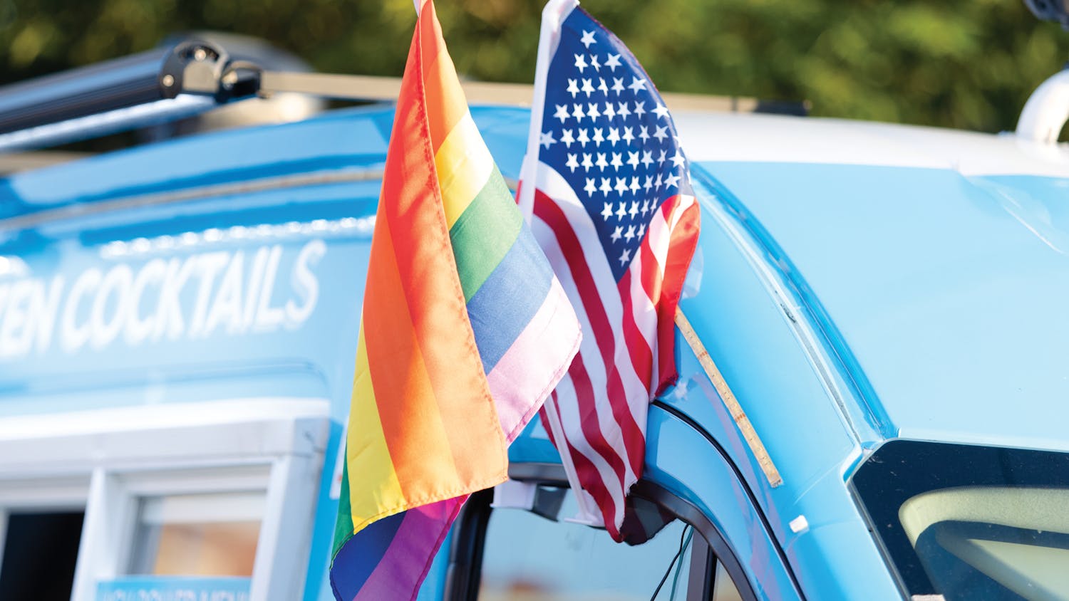 An LGBTQIA+ flag sits alongside a U.S. flag in a vendor’s truck window during the Outfest festival on June 4, 2022 on Park Street in Columbia, SC. Outfest featured performances, food and vendors in honor of Pride month.