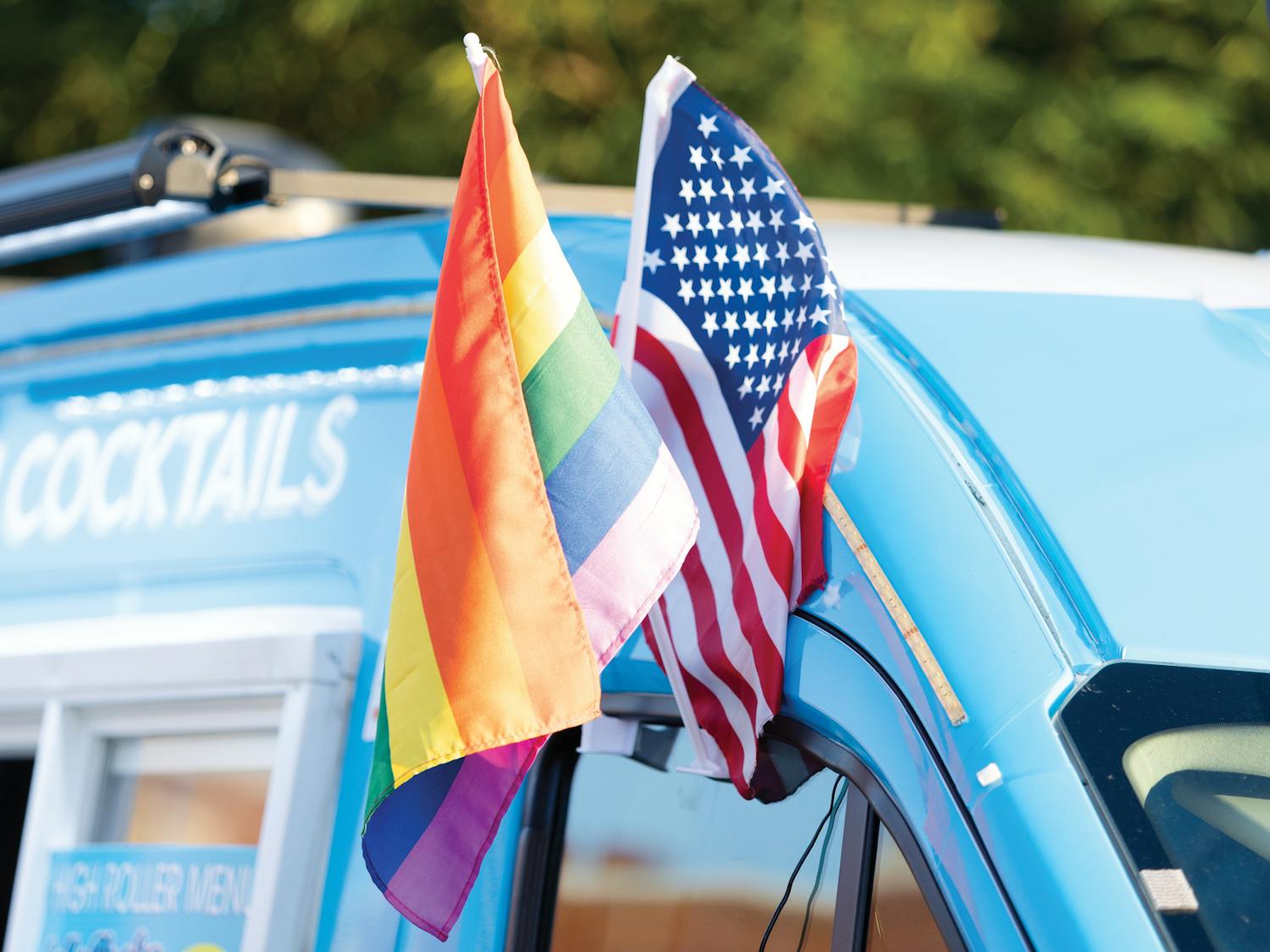 An LGBTQIA+ flag sits alongside a U.S. flag in a vendor’s truck window during the Outfest festival on June 4, 2022 on Park Street in Columbia, SC. Outfest featured performances, food and vendors in honor of Pride month.