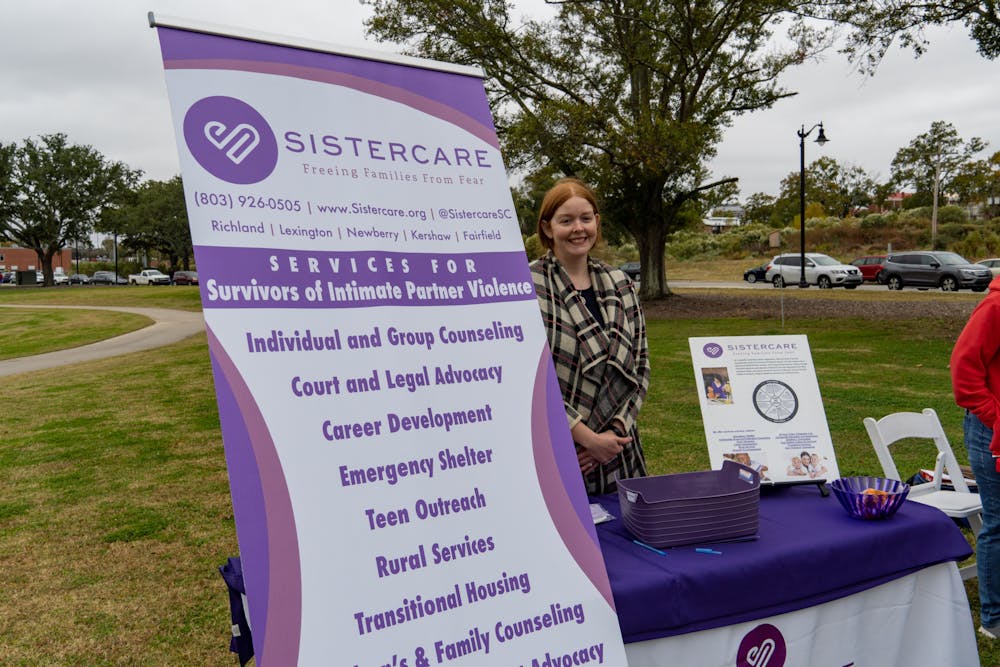 A SISTERCARE table sits in Page Ellington Park for the 2022 Mayor's Walk Against Domestic Violence. Community members and organizations gathered for the walk to fight against domestic violence.