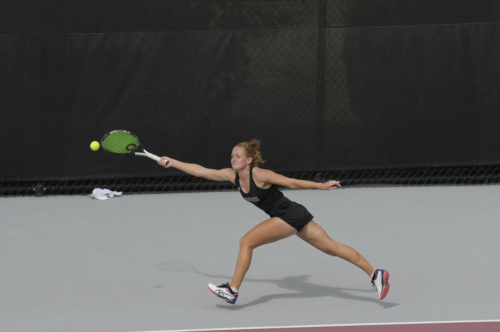 Junior Megan Davies keeps her eye on the ball as she follows through with her swing.&nbsp;