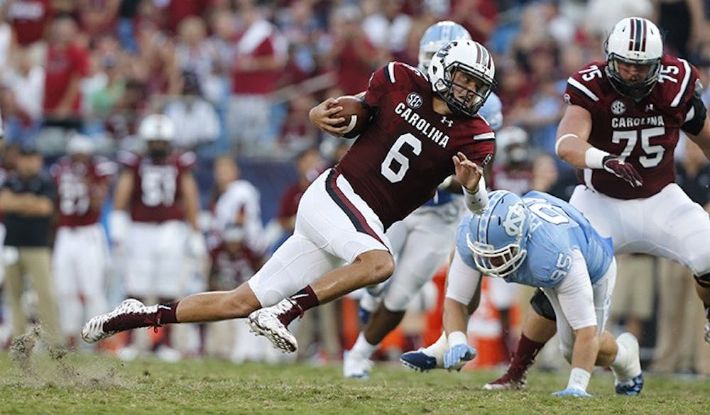 South Carolina quarterback Connor Mitch (6) runs for yardage during the first half against North Carolina in the Belk College Kickoff at Bank of America Stadium in Charlotte, N.C., on Thursday, Sept. 3, 2015. (Ethan Hyman/Raleigh News &amp; Observer/TNS)