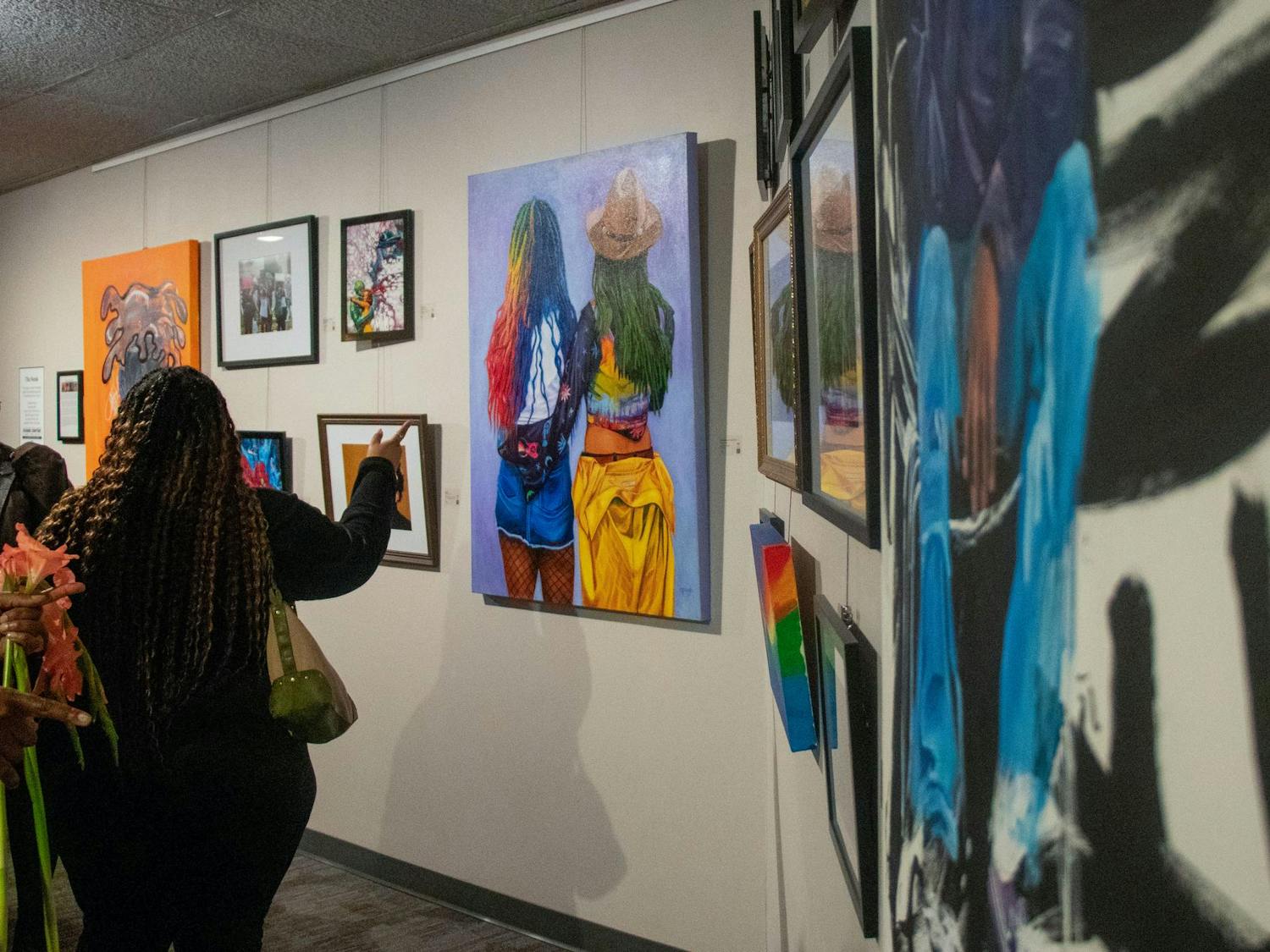 Attendees look at the artwork on display at the SC Pride Museum at the Koger Center on Oct. 17, 2024. The exhibit highlights LGBTQIA+ culture in the state and was one of the events of South Carolina Pride.