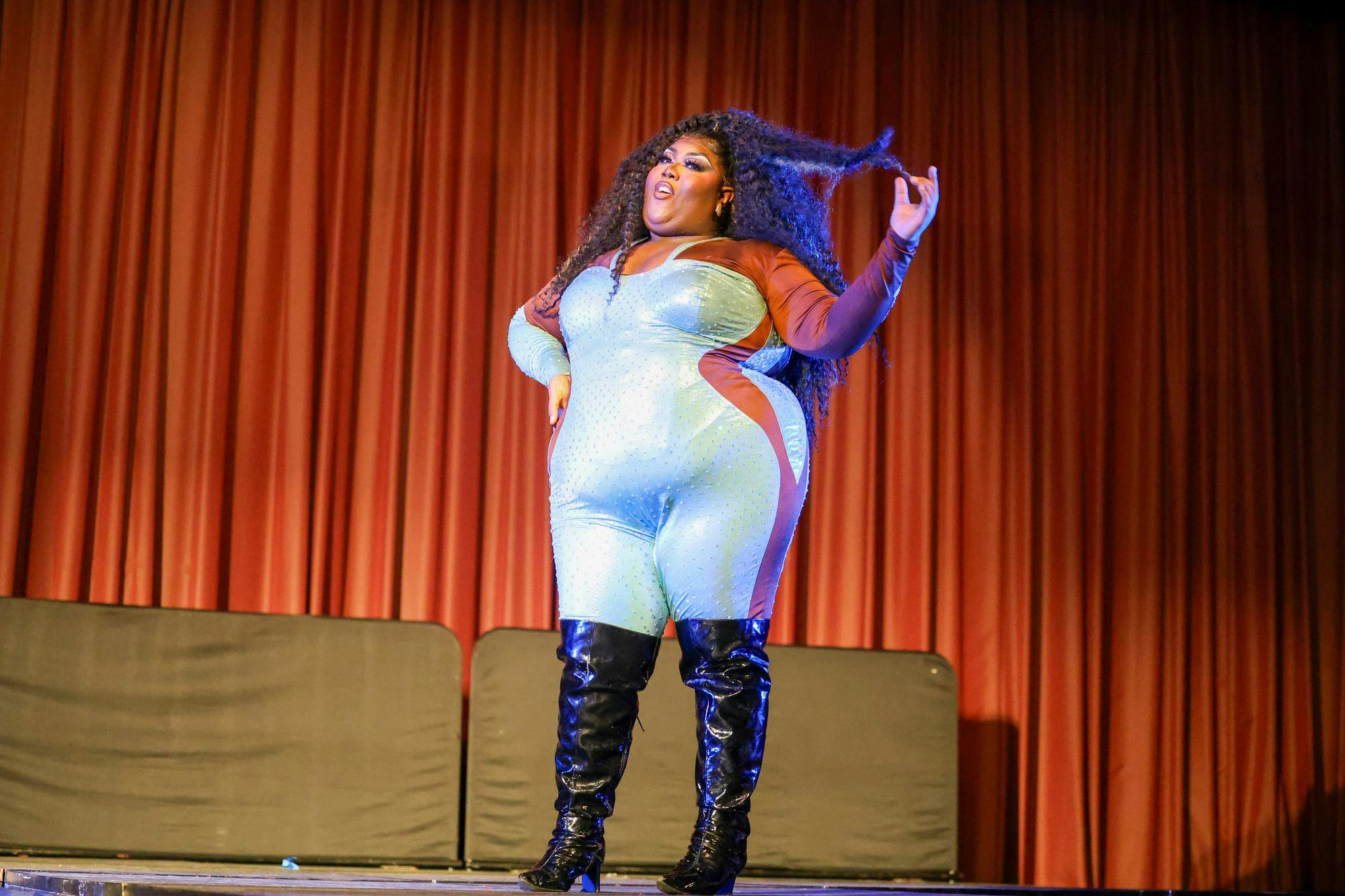 Drag performer Kenya Pleaser lip-syncs to a Lizzo song during the Birdcage drag show in the Russell House Ballroom on April 14, 2026. Kenya Pleaser appeared as a contestant on the 18th season of "RuPaul’s Drag Race."