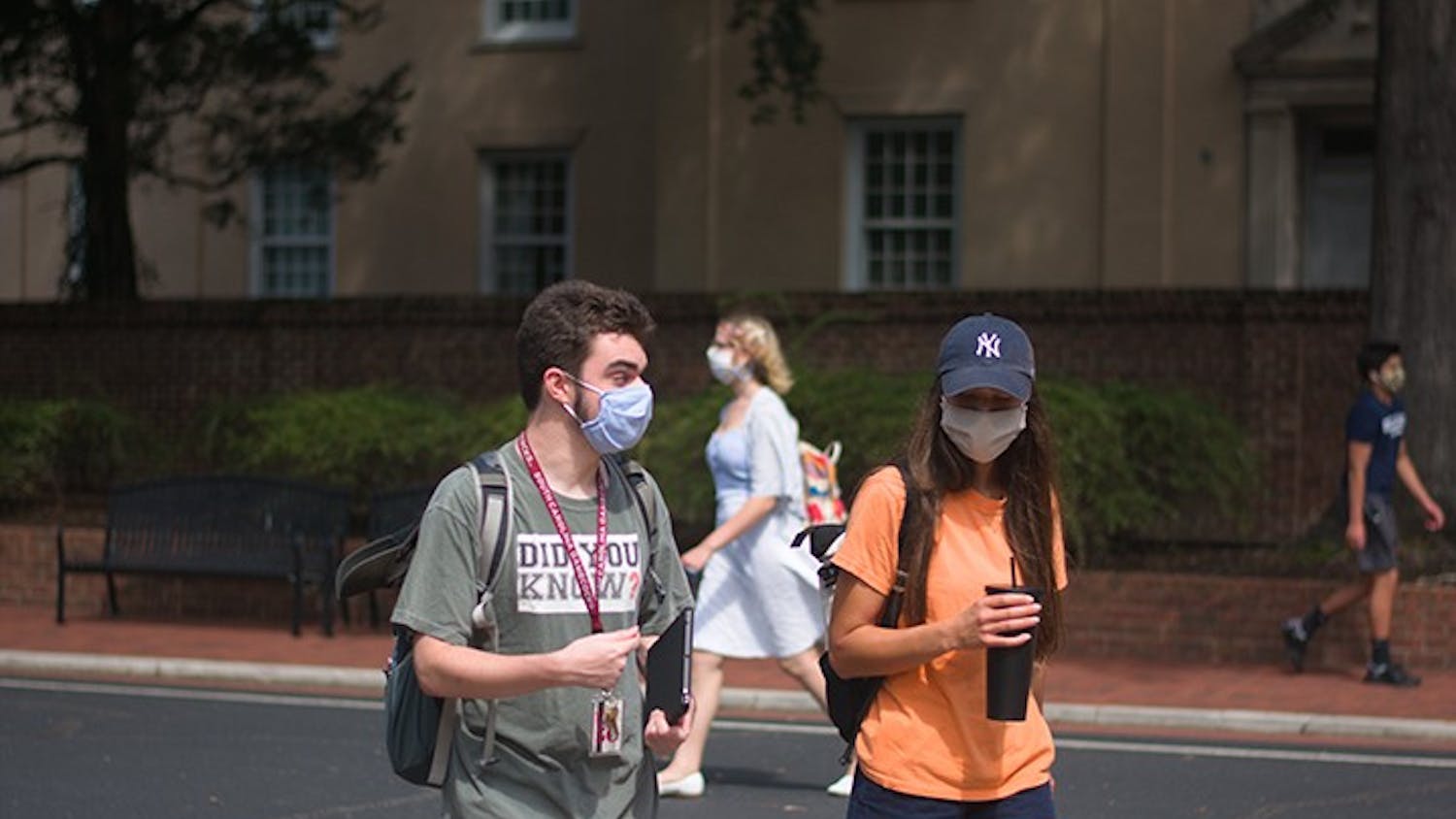 Students walk on campus with masks on. The university has documented over 1,000 student violations related to COVID-19 this semester.