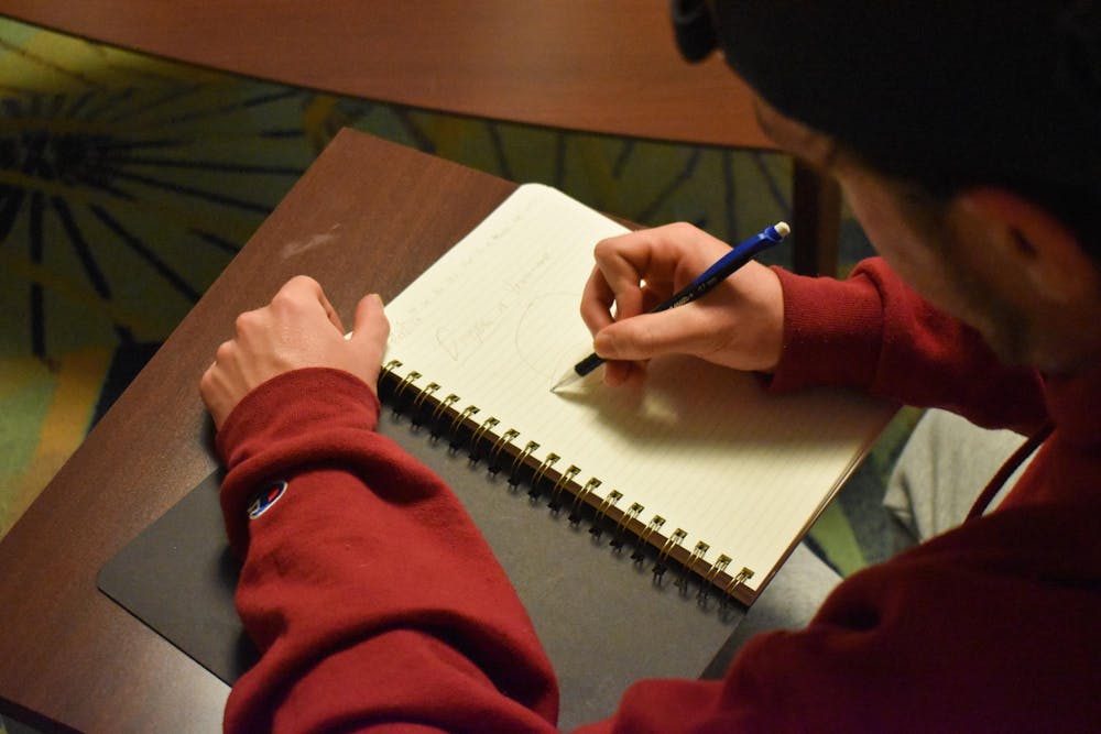 <p>A photo illustration of a person writing in a journal on Oct. 1, 2024. Student journalists play a vital role in keeping members of the campus community educated and informed of what is happening on campus and in the surrounding community.</p>