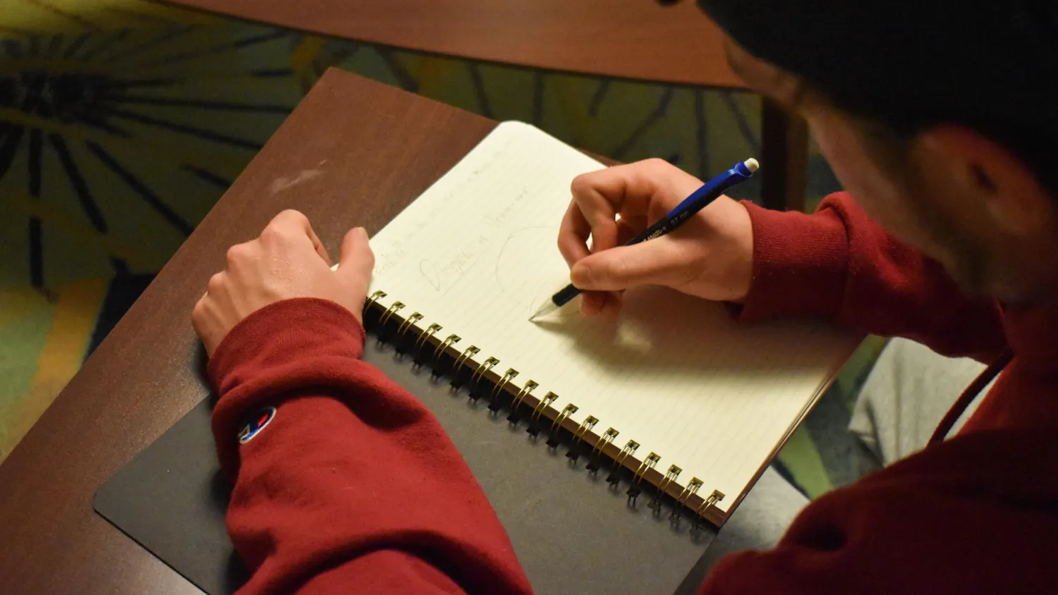 A photo illustration of a person writing in a journal on Oct. 1, 2024. Student journalists play a vital role in keeping members of the campus community educated and informed of what is happening on campus and in the surrounding community.
