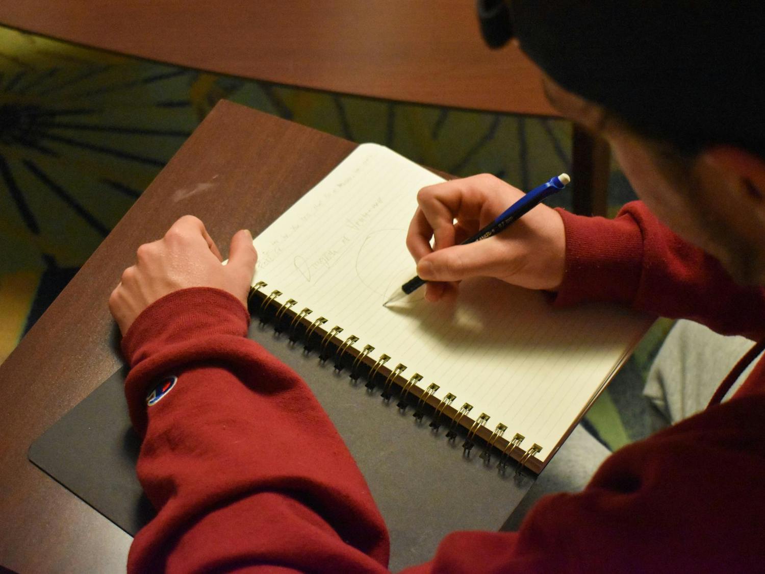 A photo illustration of a person writing in a journal on Oct. 1, 2024. Student journalists play a vital role in keeping members of the campus community educated and informed of what is happening on campus and in the surrounding community.