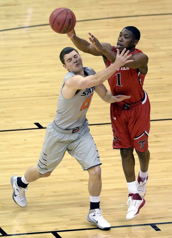 Oklahoma State's Christien Sager (15) tries to slow down Texas Tech's Randy Onwuasor (1) during the first round of the Big 12 Tournament at the Sprint Center in Kansas City, Mo., Wednesday, March 12, 2014. (John Sleezer/Kansas City Star/MCT)