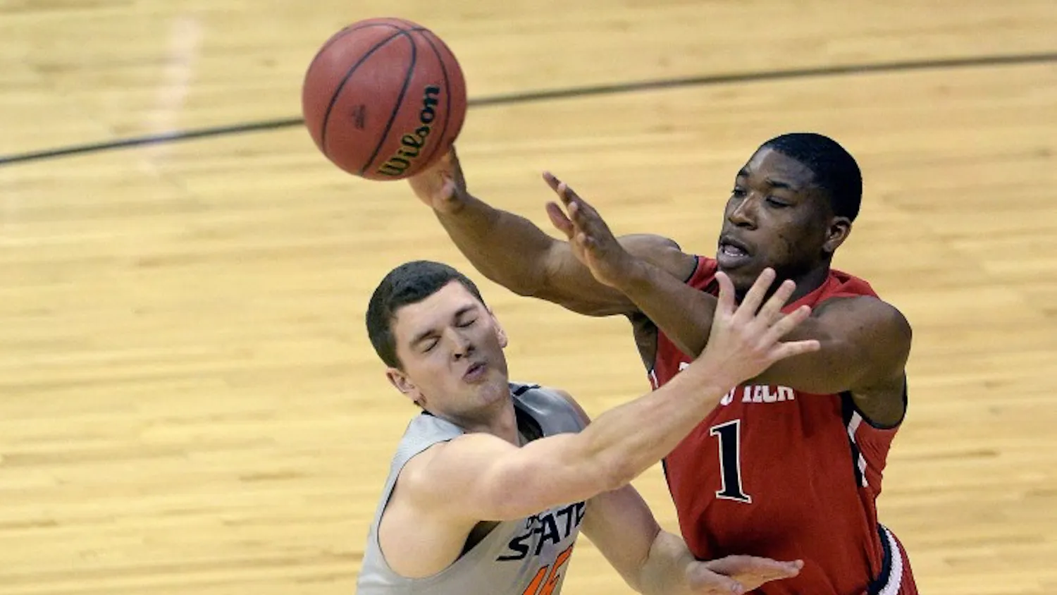 Oklahoma State's Christien Sager (15) tries to slow down Texas Tech's Randy Onwuasor (1) during the first round of the Big 12 Tournament at the Sprint Center in Kansas City, Mo., Wednesday, March 12, 2014. (John Sleezer/Kansas City Star/MCT)