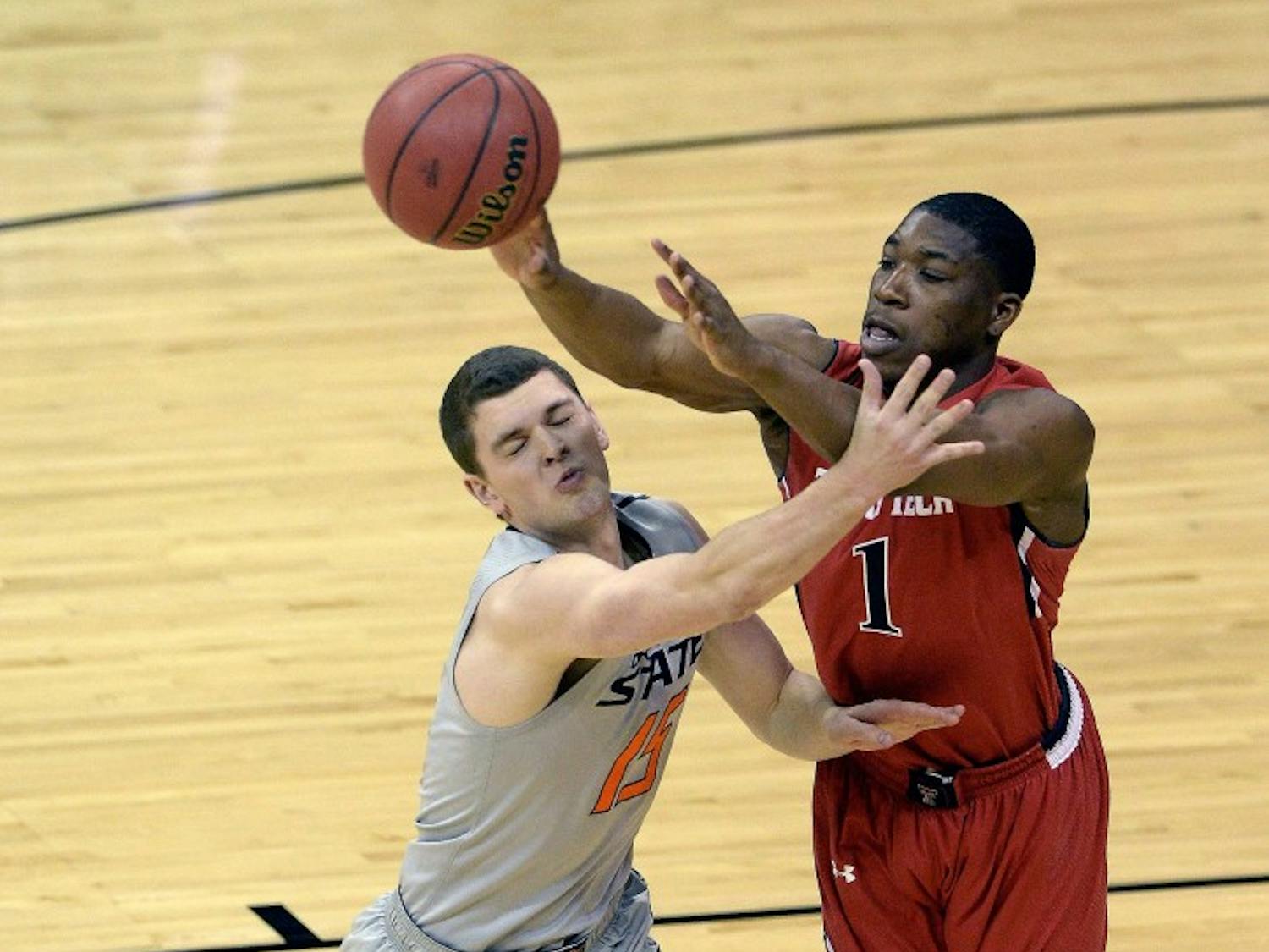 Oklahoma State's Christien Sager (15) tries to slow down Texas Tech's Randy Onwuasor (1) during the first round of the Big 12 Tournament at the Sprint Center in Kansas City, Mo., Wednesday, March 12, 2014. (John Sleezer/Kansas City Star/MCT)