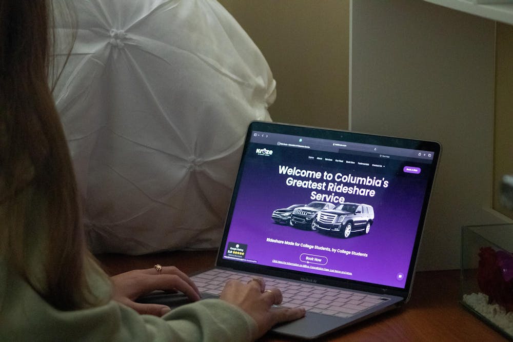 <p>A photo illustration of a University of South Carolina student browsing KolaKruze.com on Oct. 28, 2024. KolaKruze.com is a rideshare website created by a USC alumnus to provide a safe transportation option for students.</p>