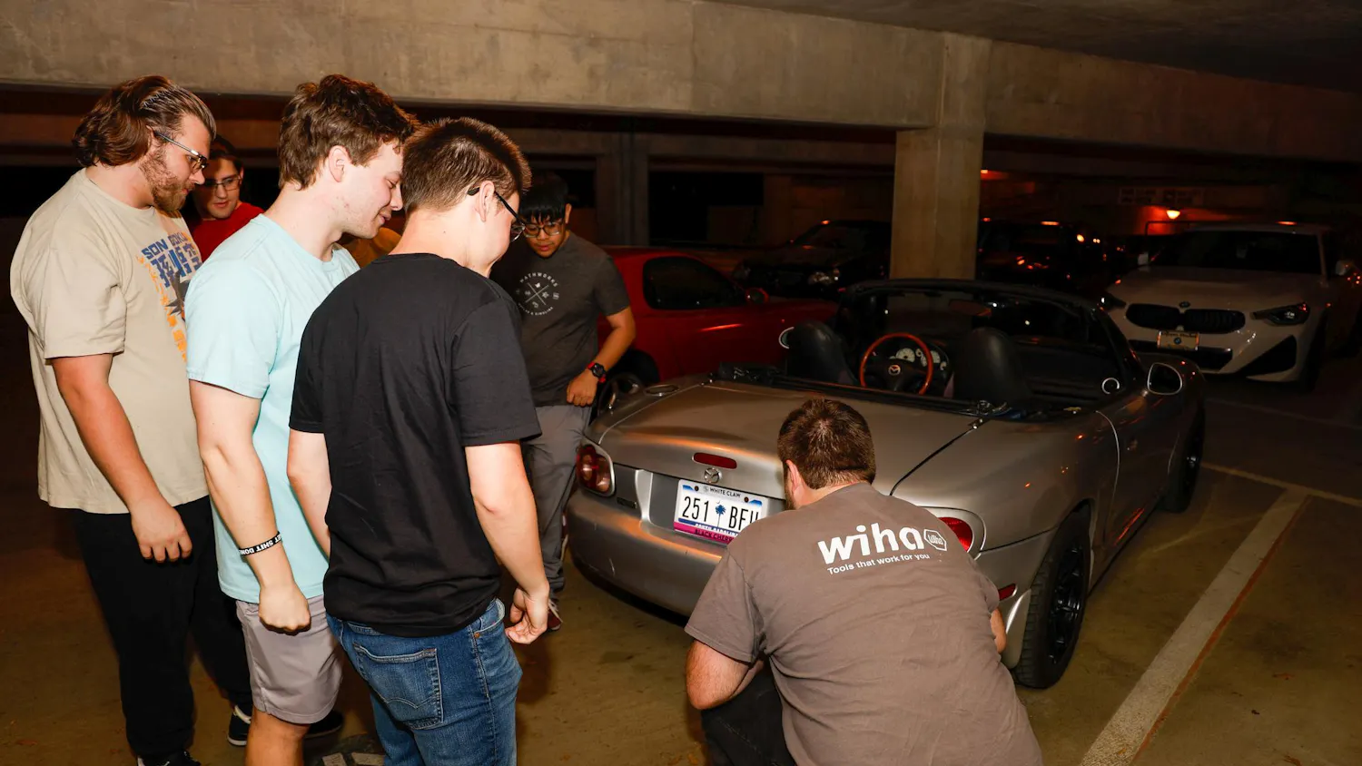 Members of the Carolina Automotive Club examine a club member's new muffler during their weekly meeting at Pendleton Garage on March 25, 2025. All students, regardless of major, are welcome to join and share their love of cars, trucks and motorcycles.