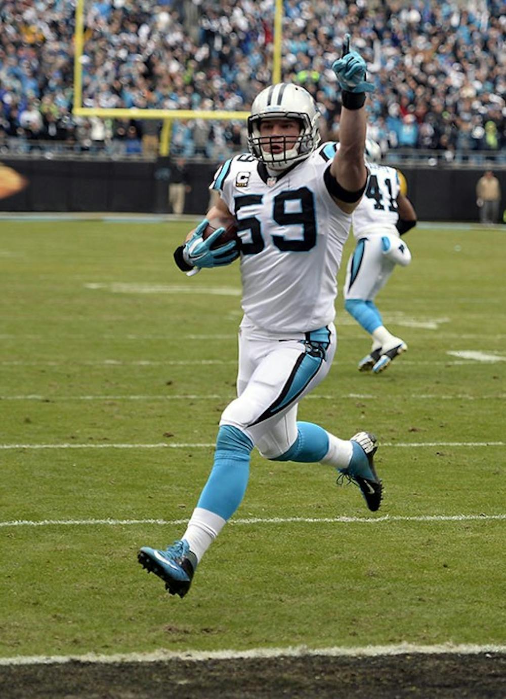 Carolina Panthers&apos; Luke Kuechly (59) celebrates as he returns an interception for a touchdown during the first quarter on Sunday, Jan. 17, 2016, at Bank of America Stadium in Charlotte, N.C. (David T. Foster III/Charlotte Observer/TNS)