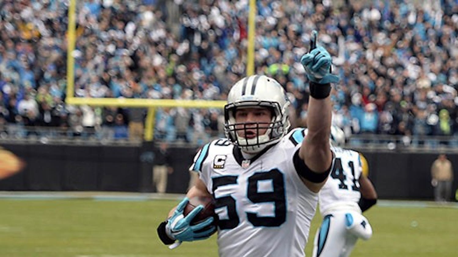 Carolina Panthers' Luke Kuechly (59) celebrates as he returns an interception for a touchdown during the first quarter on Sunday, Jan. 17, 2016, at Bank of America Stadium in Charlotte, N.C. (David T. Foster III/Charlotte Observer/TNS)