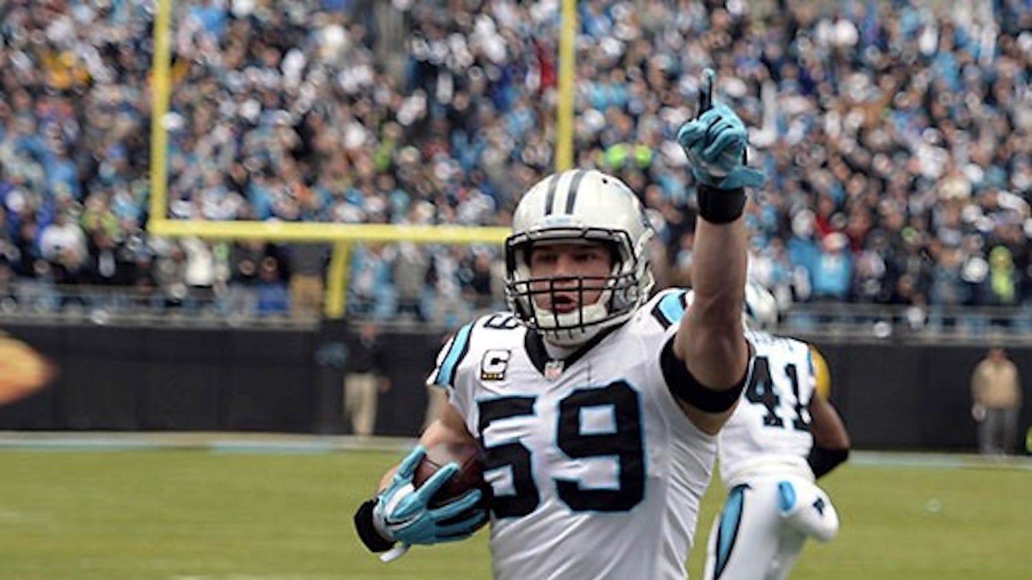 Carolina Panthers&apos; Luke Kuechly (59) celebrates as he returns an interception for a touchdown during the first quarter on Sunday, Jan. 17, 2016, at Bank of America Stadium in Charlotte, N.C. (David T. Foster III/Charlotte Observer/TNS)