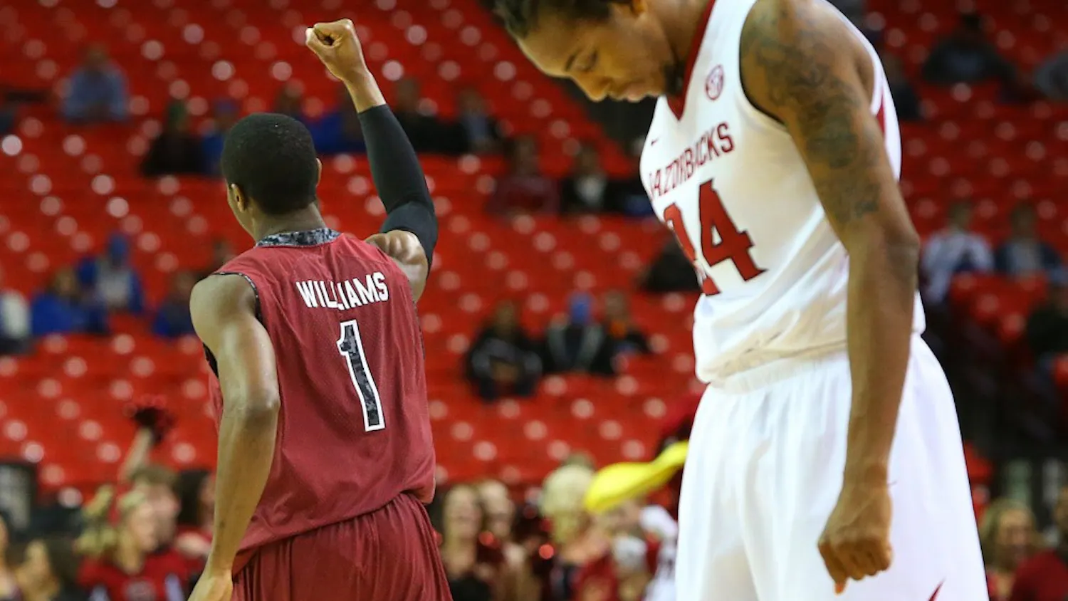South Carolina's Brenton Williams (1) celebrates as Arkansas' Michael Qualls hangs his head as time expires in the Gamecocks' 71-69 victory in the second round of the SEC Tournament on Thursday, March 13, 2014, at the Georgia Dome in Atlanta. (Curtis Compton/Atlanta Journal-Constitution/MCT)