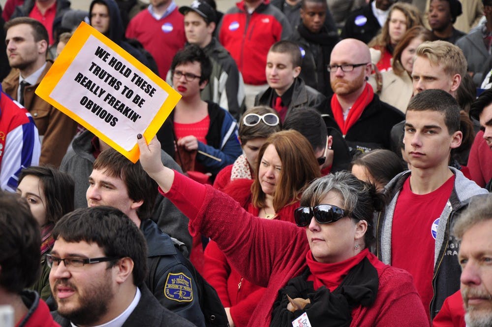 Many protesters at Tuesday's rally for same-sex marriage brought signs that expressed their opposition to Proposition 8 and the Defense of Marriage Act.