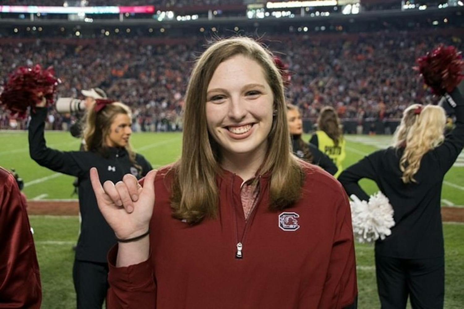 Alexis Kiser holding up the "Spur's Up" hand sign. Kiser became Cocky during her second year at USC.