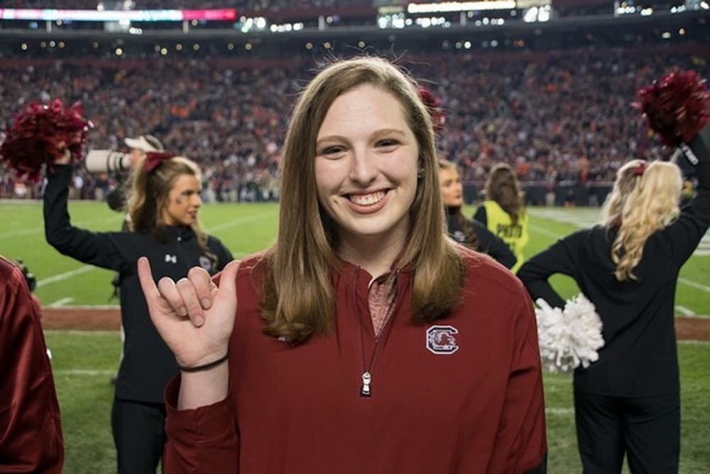 <p>Alexis Kiser holding up the "Spur's Up" hand sign. Kiser became Cocky during her second year at USC.</p>