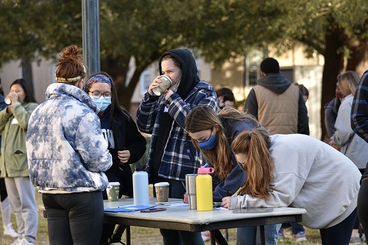 Two students signed up for Service Saturday pick their volunteer site. The students then take busses to their respective sites.