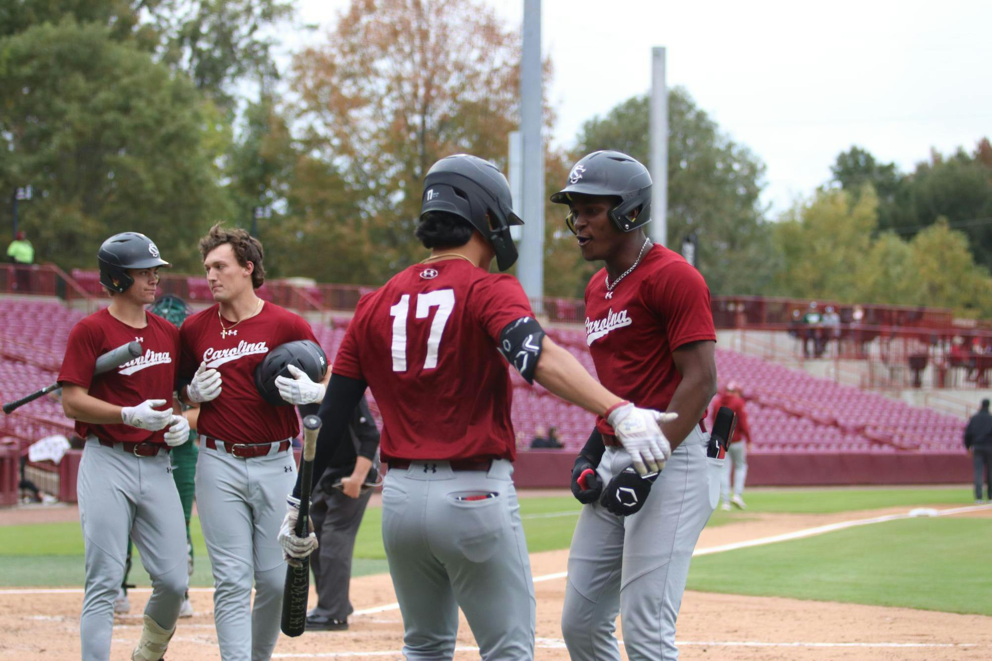 FILE — Junior outfielder Tyler Bak and sophomore infielder Erik Parker celebrate at home plate during the game against Charlotte on Nov. 2, 2025.