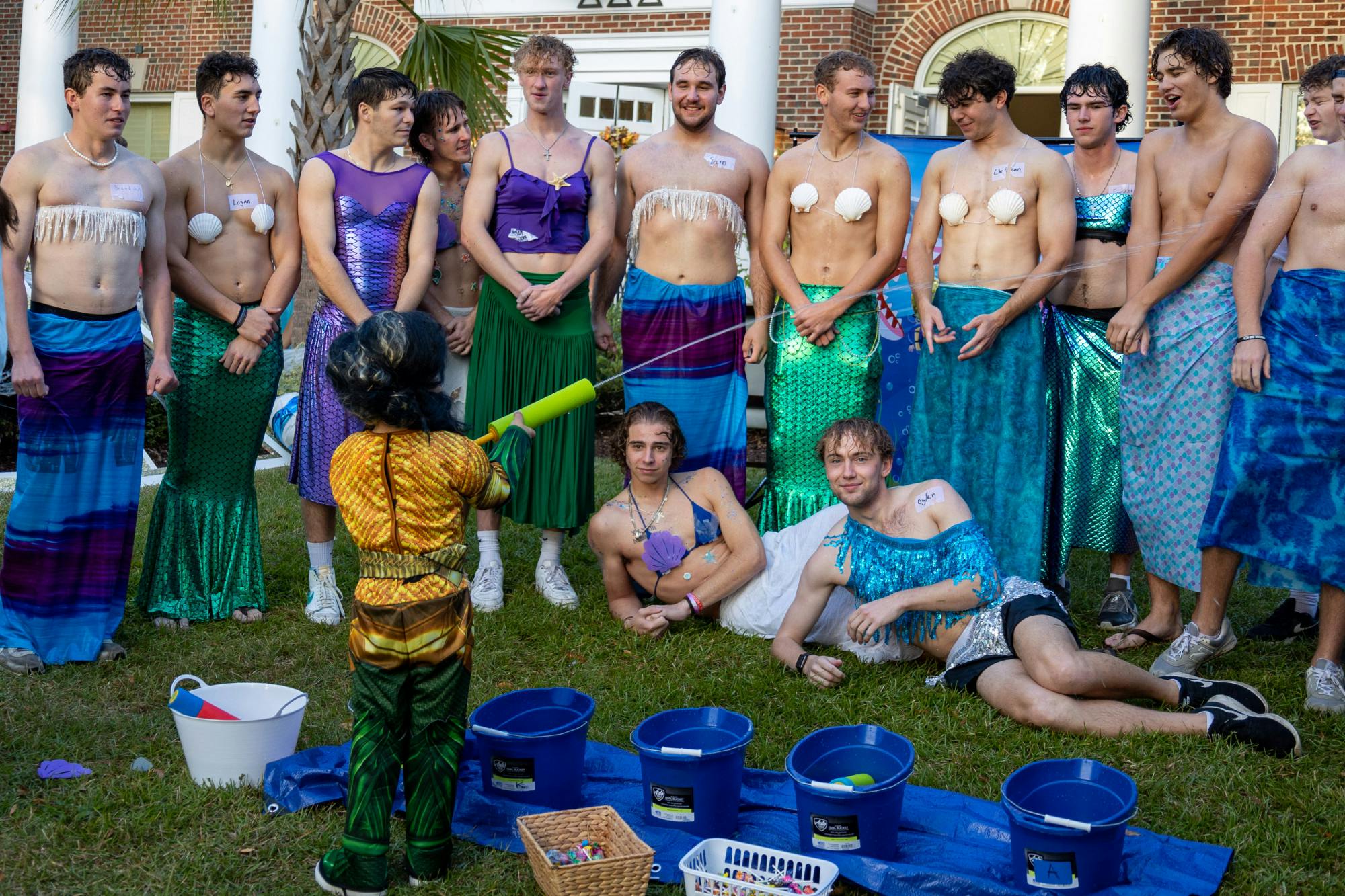 A young trick or treater sprays water at a group of Sigma fraternity brother's during the Trick or Treat with the Greeks community event on Oct. 25, 2022. USC Greek fraternities and sororities welcomed community members to Greek Village for an evening of games, fun activities, unity and trick or treating.