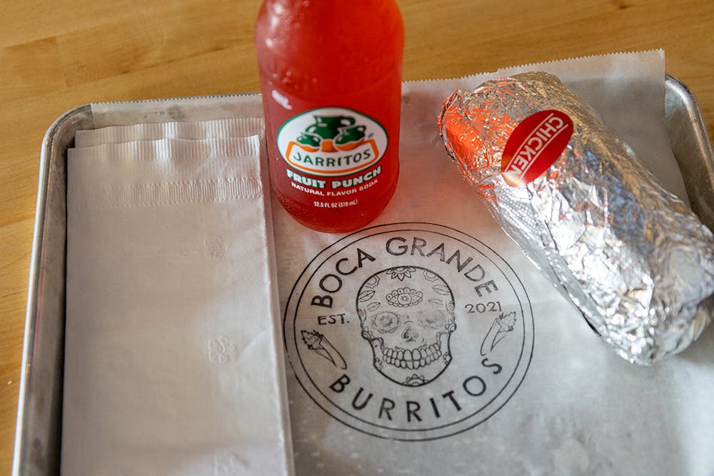 <p>Tray with Boca Grande Burritos' signature chicken burrito and a fruit punch Jarritos. They offer six signature burritos, build-your-own burritos, bowls and salads.</p>
